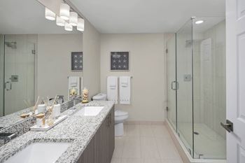 A bathroom with a sink, toilet, and shower.